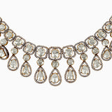 Elegant diamond and gold statement necklace with teardrop and square-cut gems
