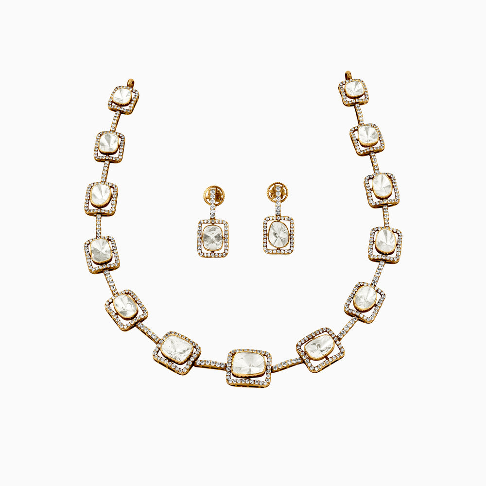 Gold necklace and earring set with square diamond pendants surrounded by smaller diamonds.