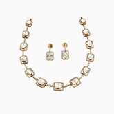 Gold necklace and earring set with square diamond pendants surrounded by smaller diamonds.