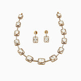 Gold necklace and earring set with square diamond pendants surrounded by smaller diamonds.