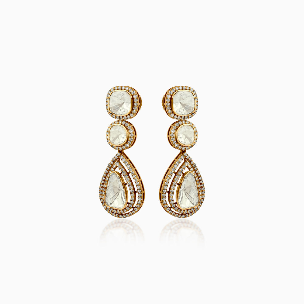 Gold drop earrings with pale stone centers, surrounded by sparkling diamond halos