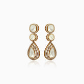 Gold drop earrings with pale stone centers, surrounded by sparkling diamond halos