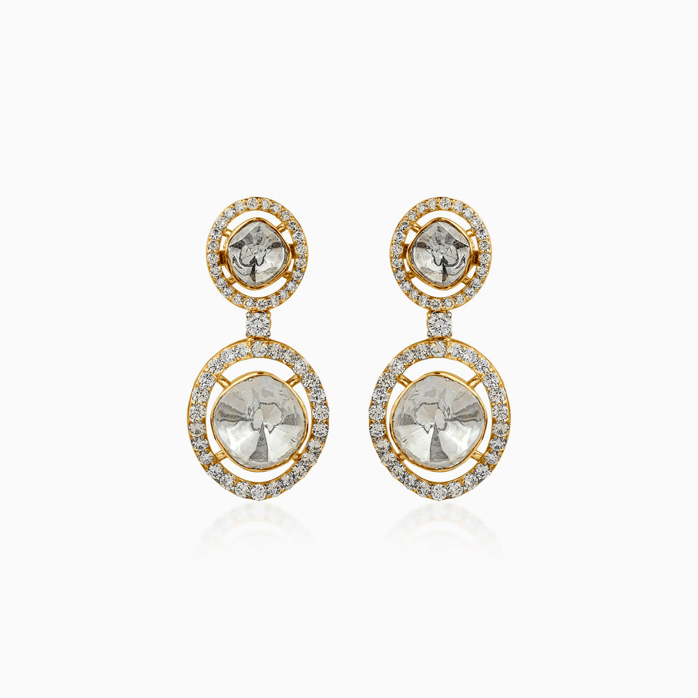 Gold drop earrings with diamond-encrusted circles and gray center stones