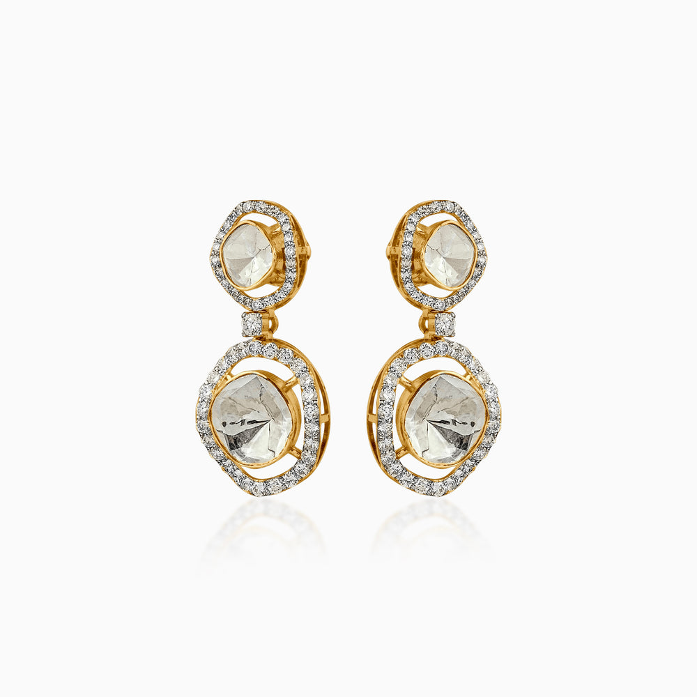 Gold drop earrings with diamond-rimmed translucent gemstones, reflecting elegance and light.