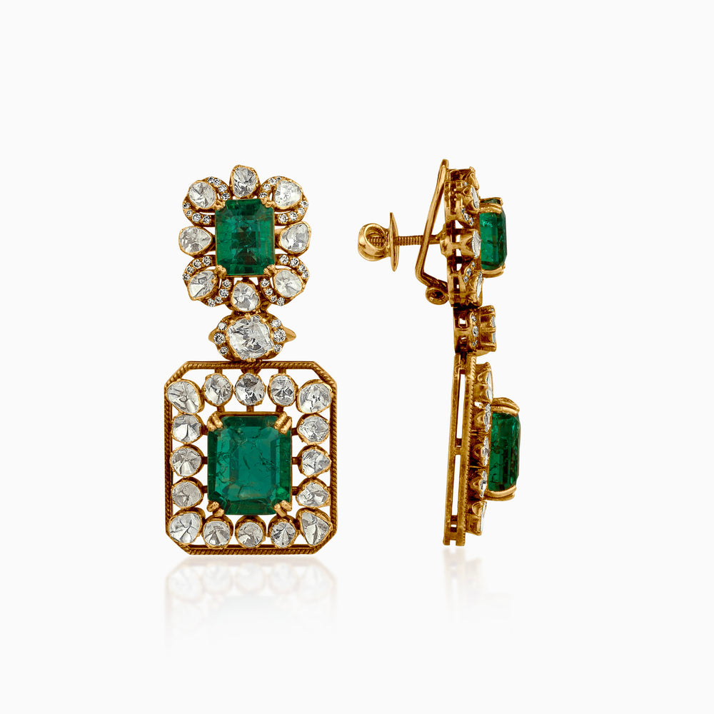 Vintage gold earrings with emerald gemstones and diamond-like white stones in ornate setting