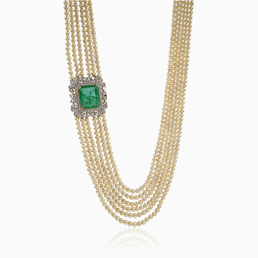 Multi-strand pearl necklace with emerald and diamond-encrusted clasp