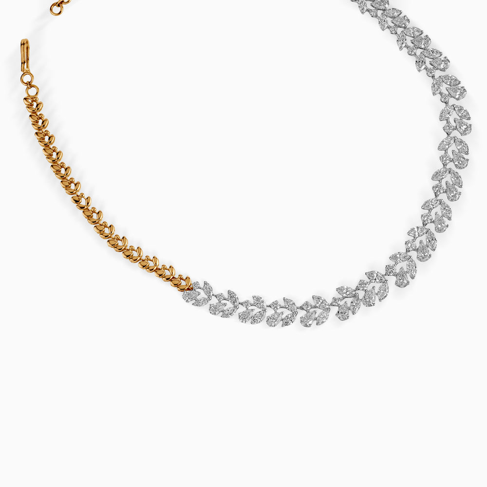 Gold and silver leaf-shaped diamond necklace with delicate, intertwining links
