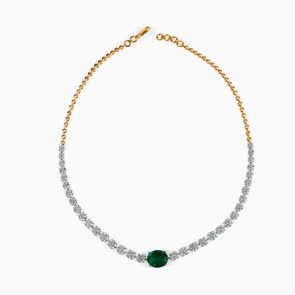 Gold and silver tennis necklace with central emerald green oval gemstone