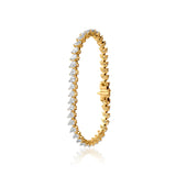 Gold tennis bracelet with pear-shaped diamonds in elegant, intricate setting