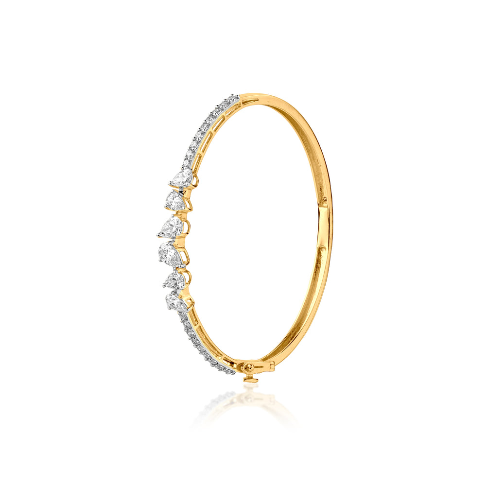 Gold bangle with graduated diamond stones on curved side, elegant jewelry design