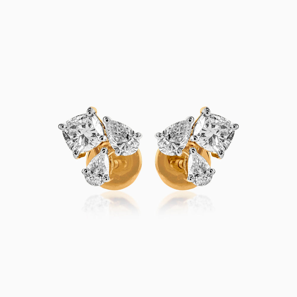 Gold stud earrings with mixed-cut white diamonds in prong settings, reflecting elegantly