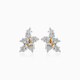 Diamond cluster earrings with gold and white gemstones in a star-like arrangement