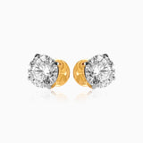 Pair of diamond stud earrings with gold backings, sparkling brilliantly against white background