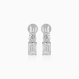 Diamond drop earrings with emerald-cut and round brilliant stones in silver setting