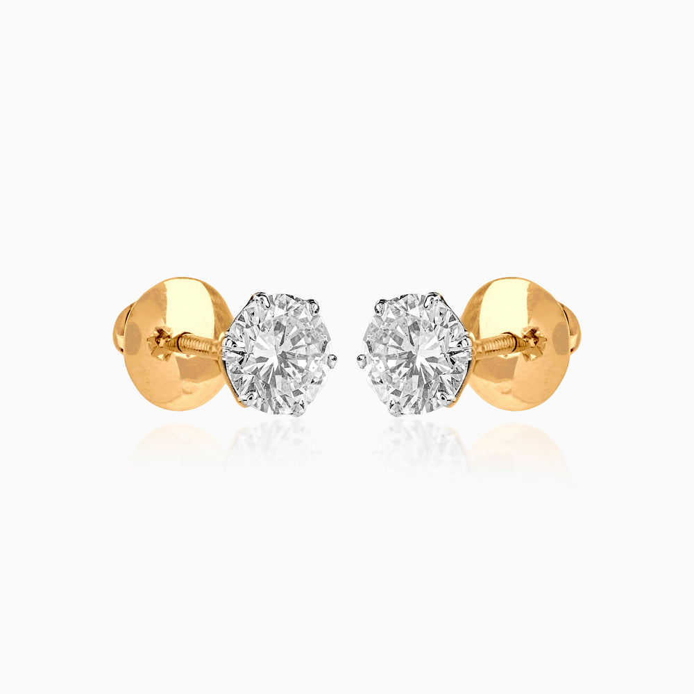 Gold stud earrings with brilliant round diamond solitaires set in classic six-prong settings.