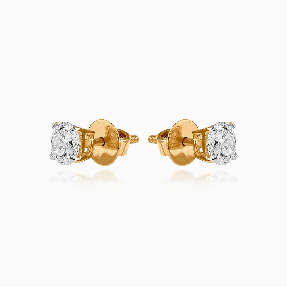 Gold stud earrings with round brilliant diamond solitaires in four-prong settings