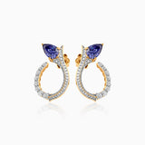 Gold and diamond earrings with blue sapphire trillion-cut stones in elegant curved design