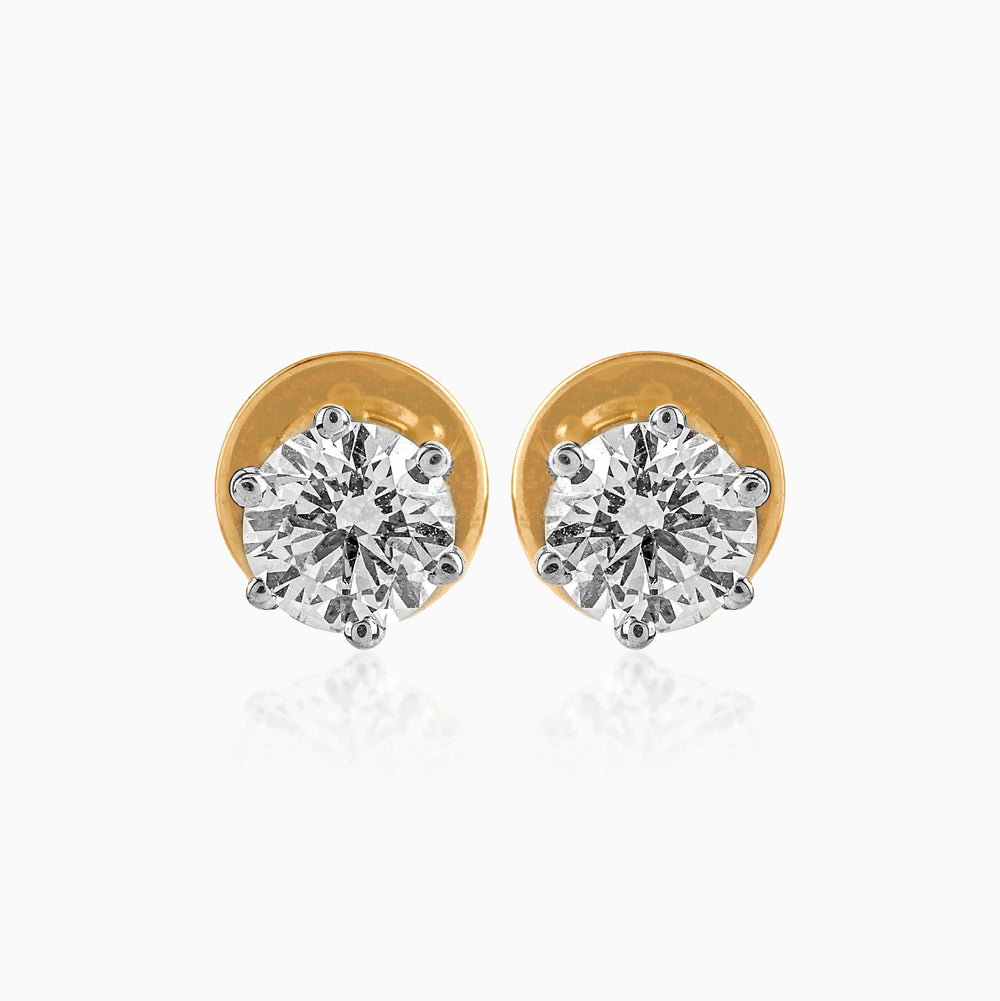 Gold-rimmed diamond stud earrings with sparkling round brilliant cut stones