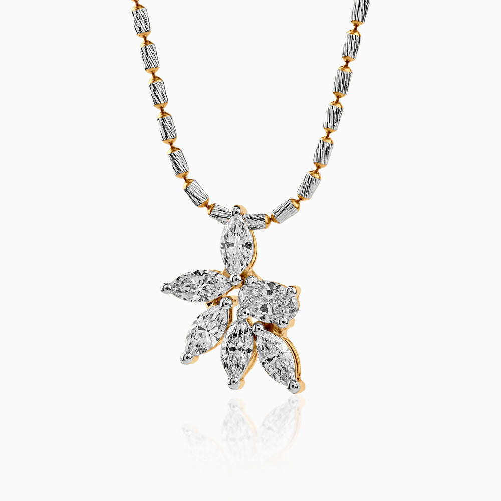 Diamond pendant with floral design on two-tone metallic chain, white and gold tones.