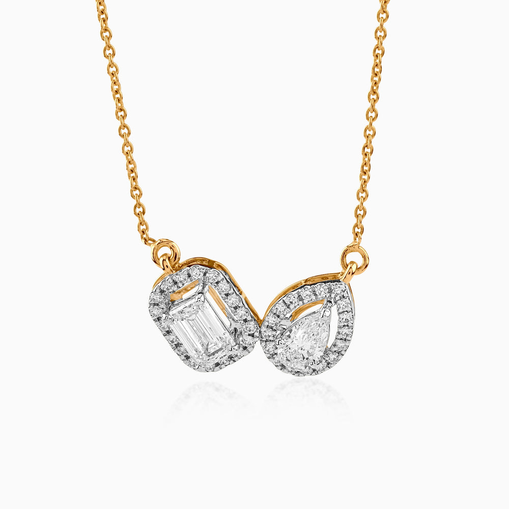 Gold necklace with two diamond-shaped pendants in emerald and pear cuts, set on delicate chain