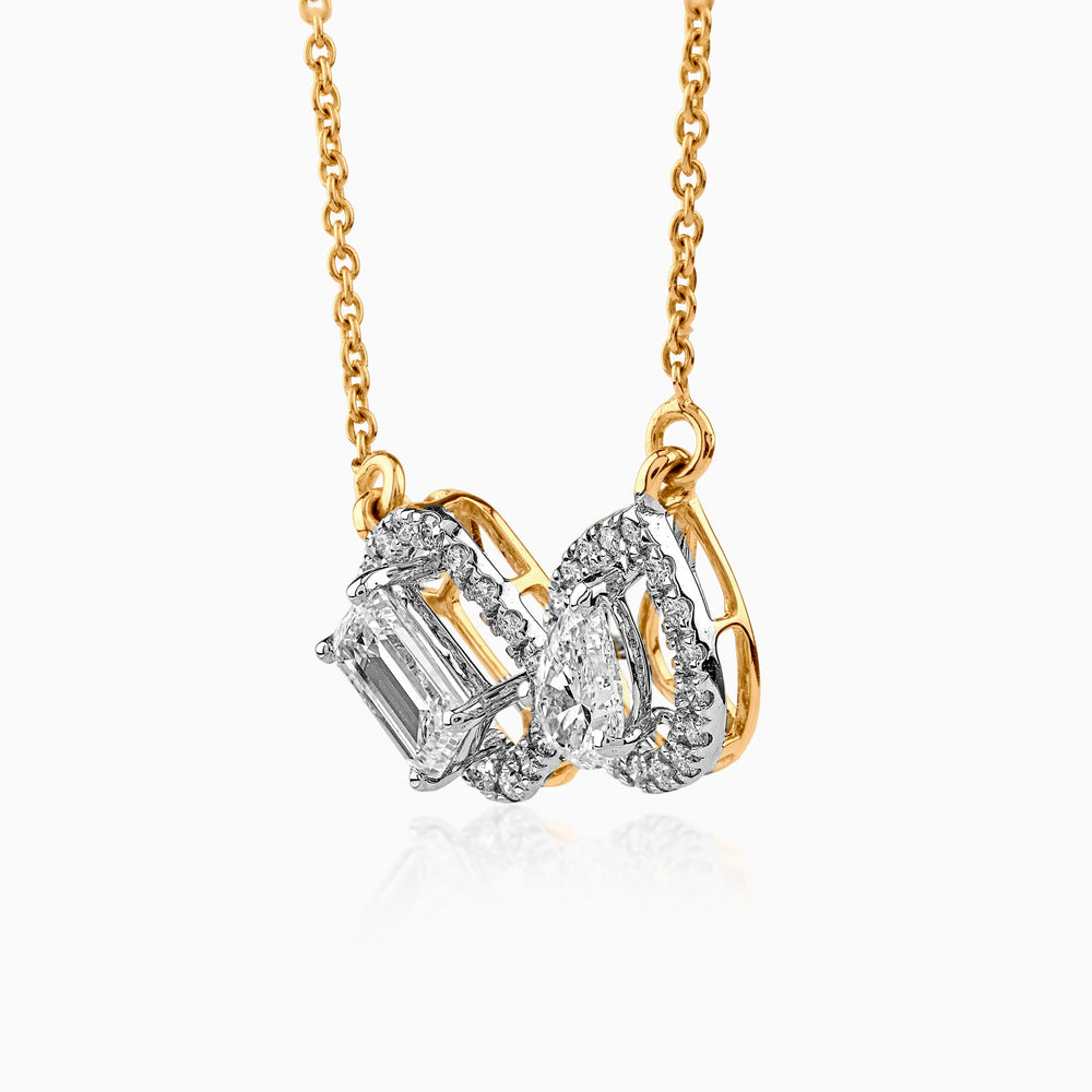 Gold and diamond pendant with emerald-cut and pear-shaped stones on delicate chain