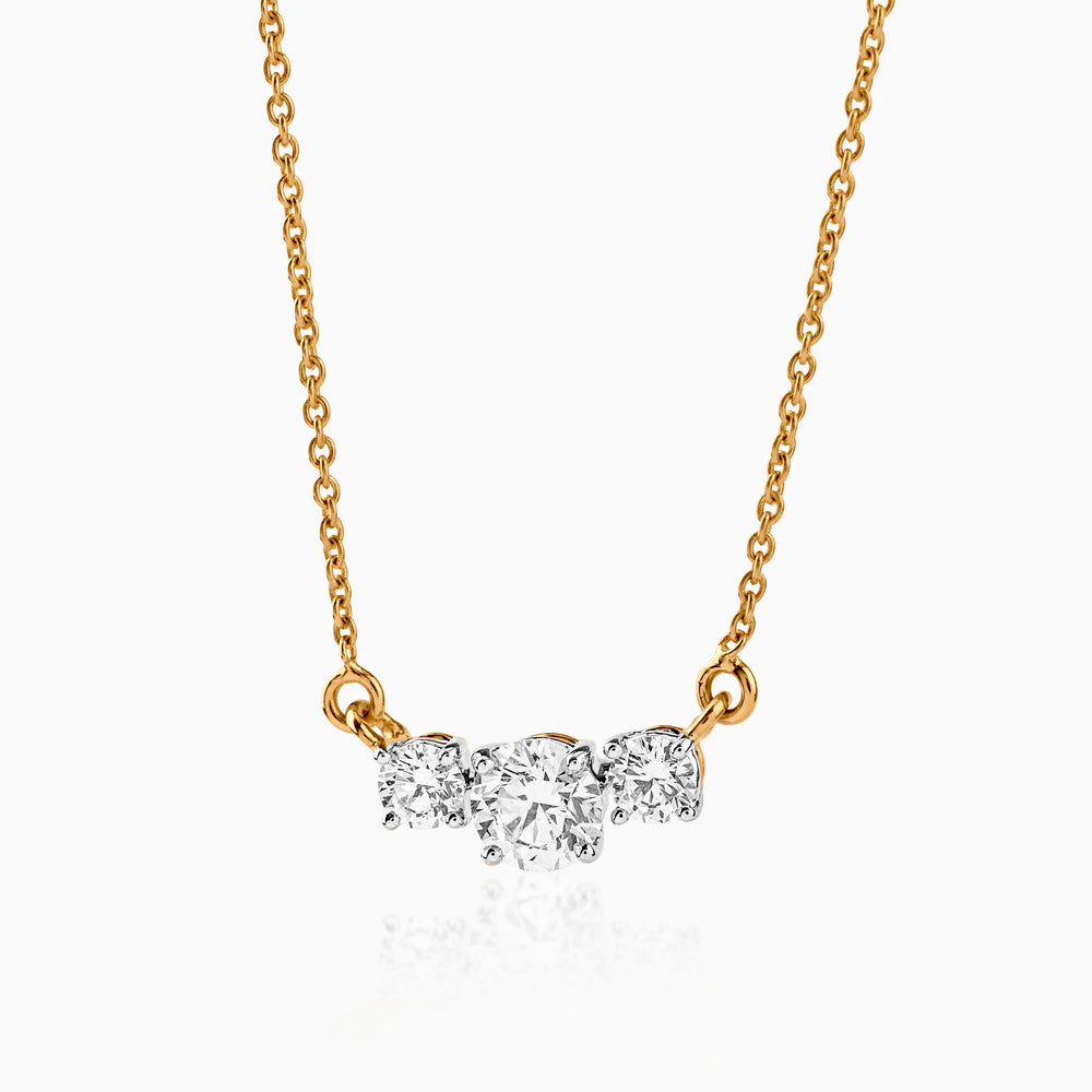Gold necklace with three sparkling round diamonds on delicate chain