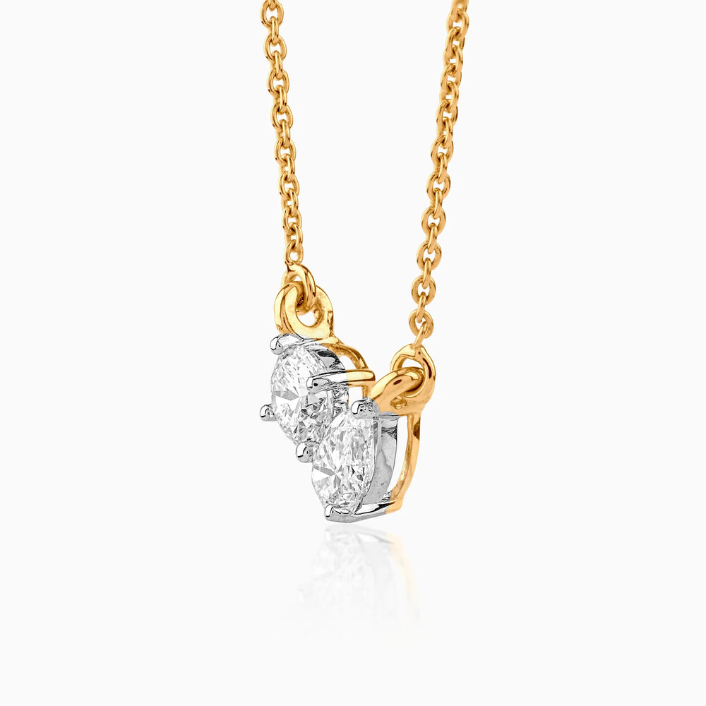 Gold chain necklace with two sparkling oval diamond pendants in white gold setting