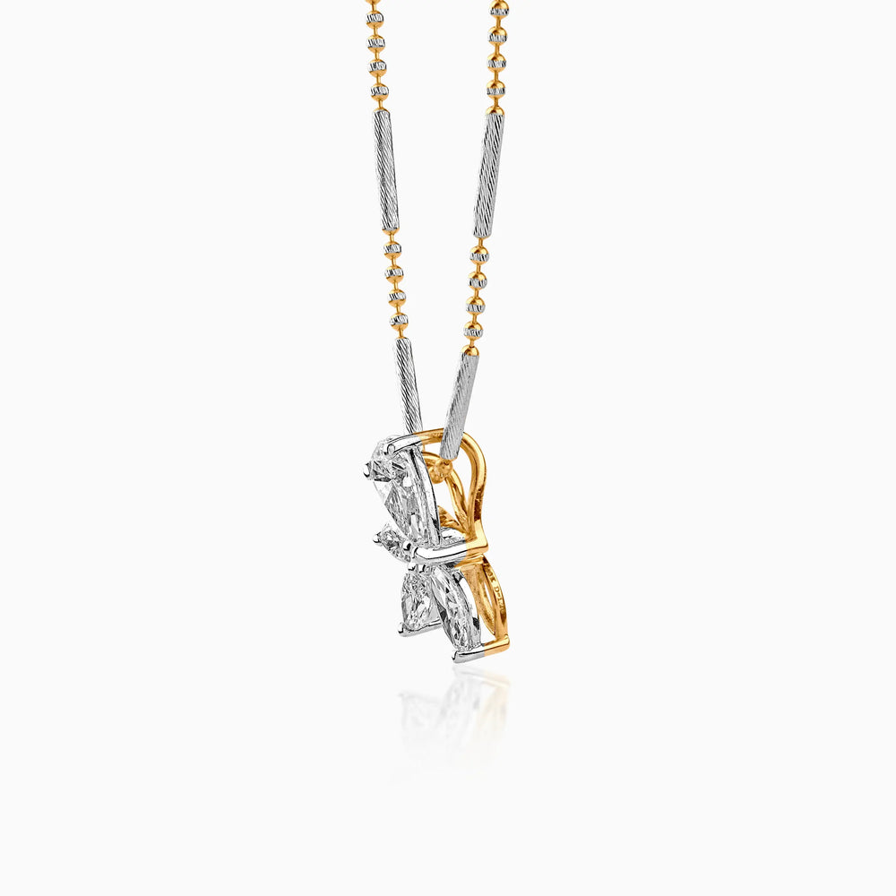 Gold and silver mixed-metal necklace with diamond pendant, hanging against white background
