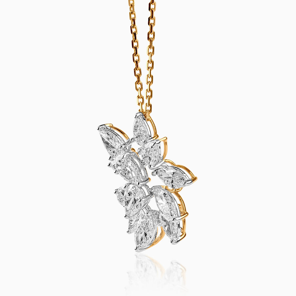 Delicate diamond flower pendant on gold chain, marquise-cut stones in elegant cluster design