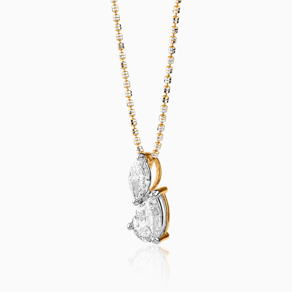 Gold and silver necklace with two teardrop-shaped diamond pendant on delicate chain
