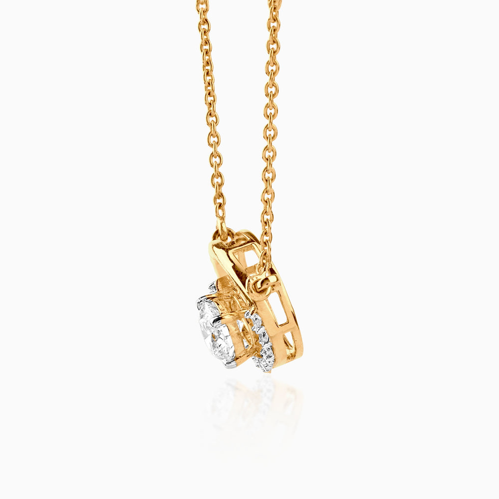 Gold pendant necklace with round diamond in intricate gold setting, hanging from delicate chain