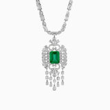 Emerald and diamond pendant necklace with intricate white gold filigree design