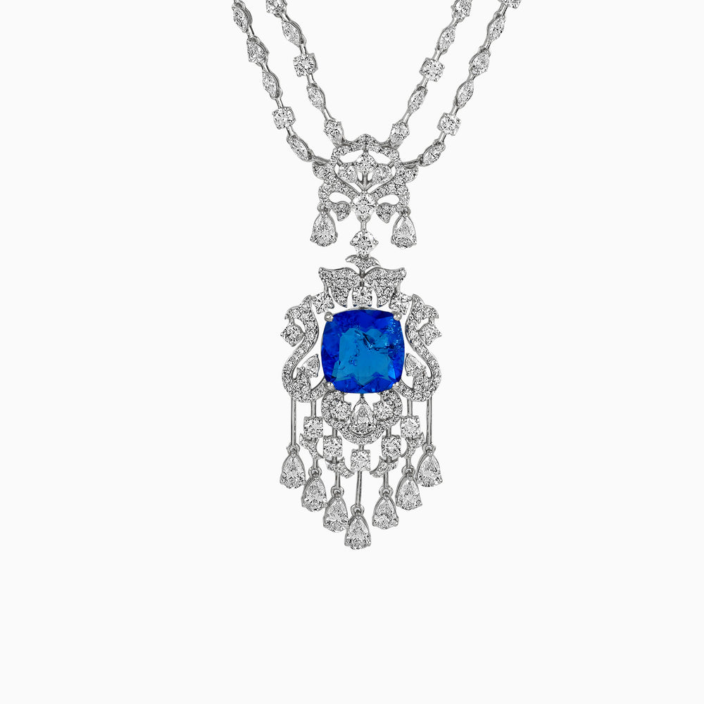 Intricate diamond necklace with vibrant blue sapphire centerpiece and cascading pendant design
