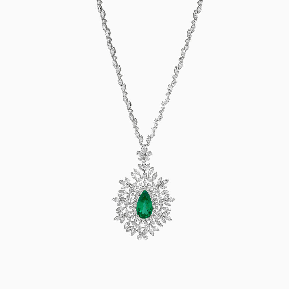 Diamond necklace with emerald teardrop pendant, surrounded by intricate floral diamond design