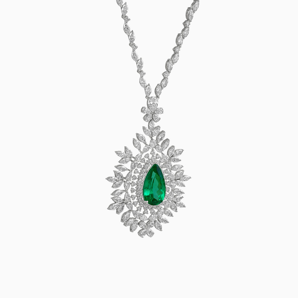 Diamond necklace with emerald green teardrop pendant surrounded by floral white diamond design