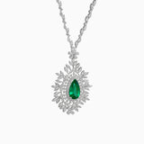 Diamond necklace with emerald green teardrop pendant surrounded by floral white diamond design