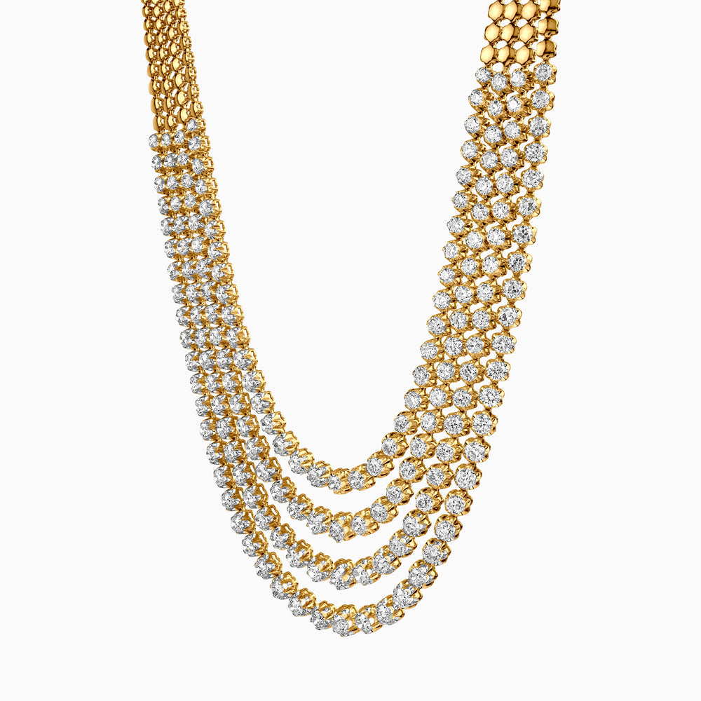 Luxurious multi-strand gold necklace with diamond-like clusters, draped elegantly.