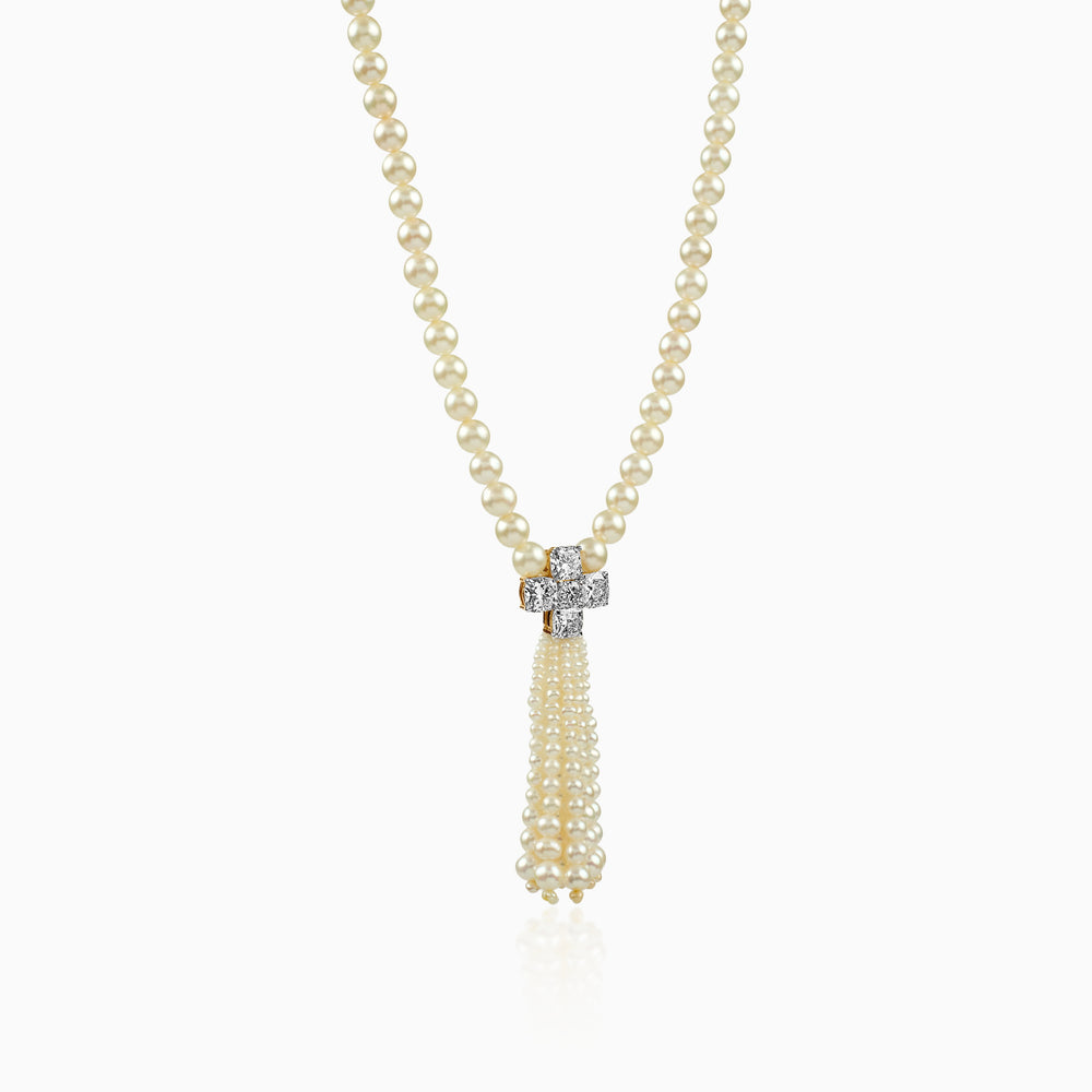 Delicate pearl necklace with diamond cross pendant and cascading pearl tassel