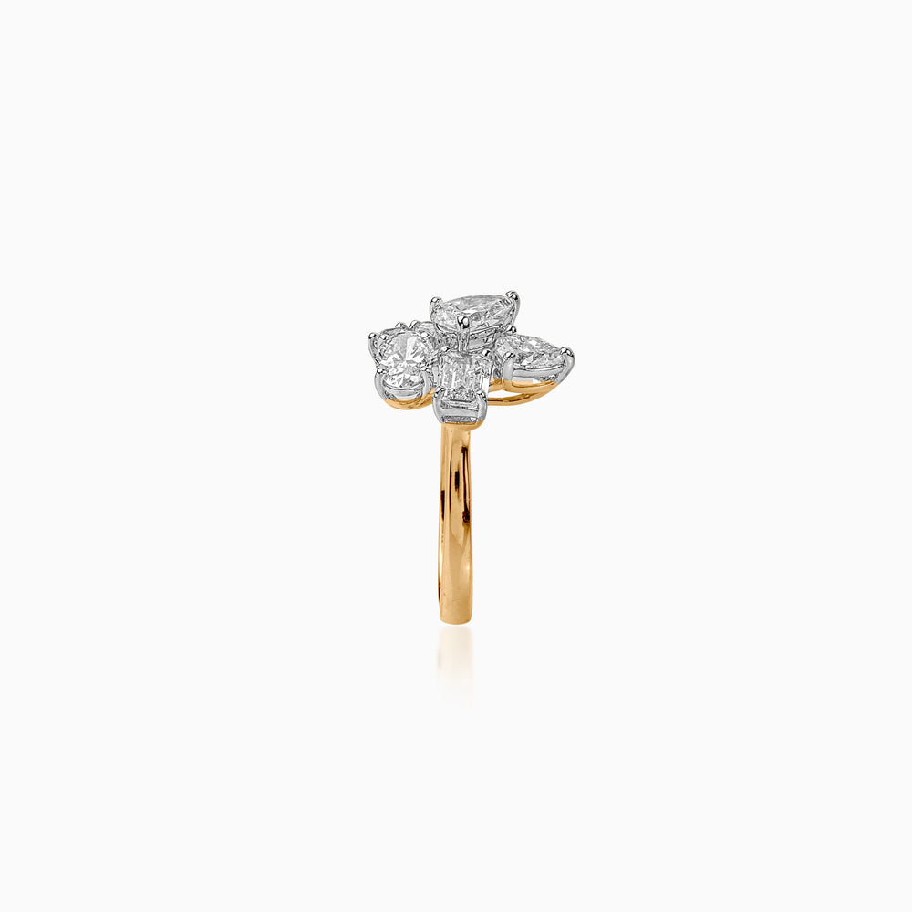 Gold ring with multi-diamond flower design, side view showing intricate white and gold setting.