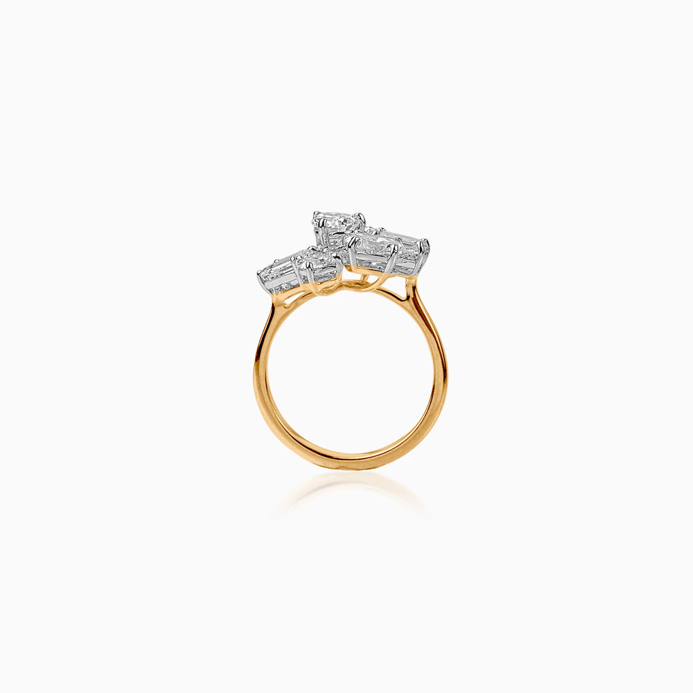 Gold ring with three emerald-cut diamond clusters on white background