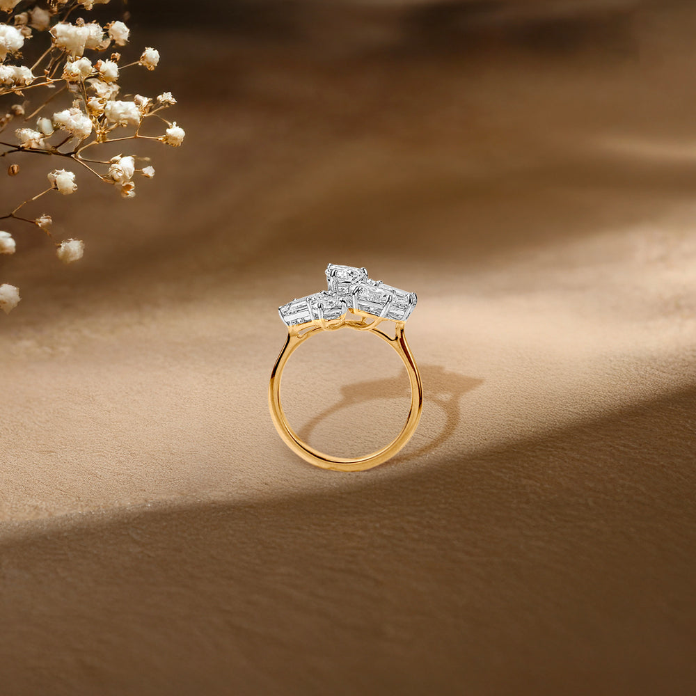 Gold ring with diamond cluster, delicate baby's breath flowers in soft-focus background