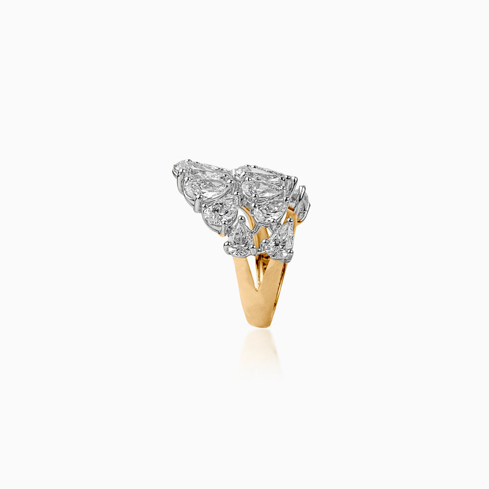 Gold ring with clustered pear-shaped diamonds, reflecting light with elegant two-tone design