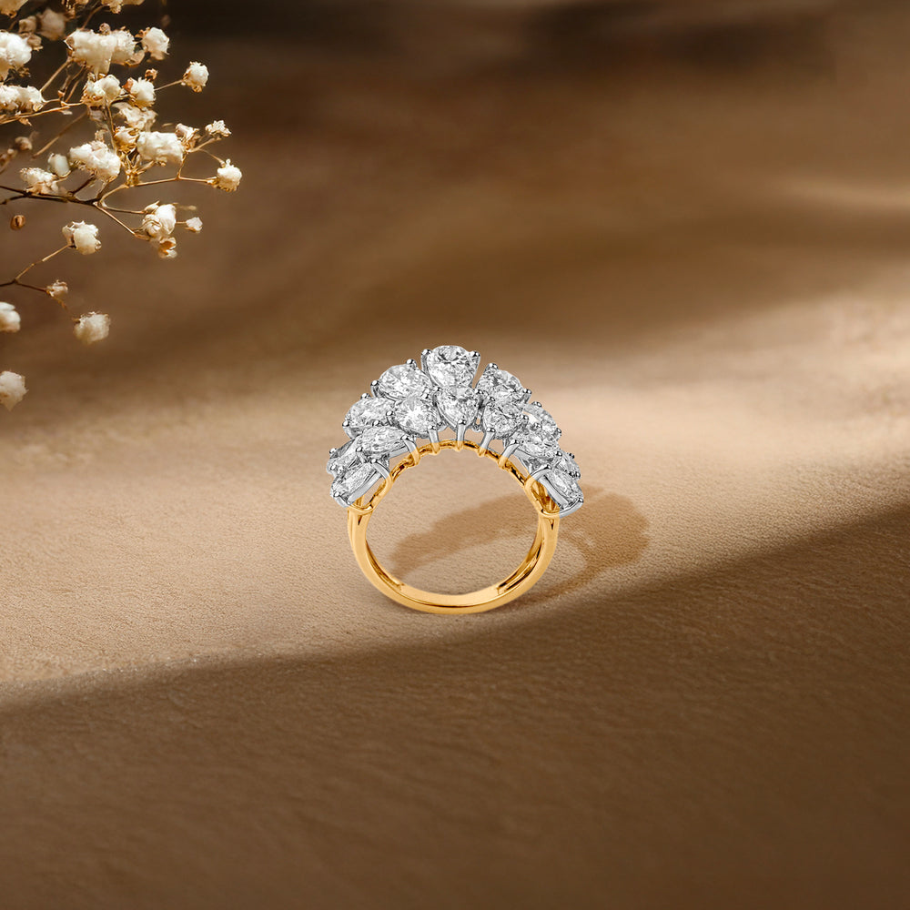 Gold ring with clustered diamond stones, soft floral background