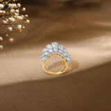 Gold ring with clustered diamond stones, soft floral background