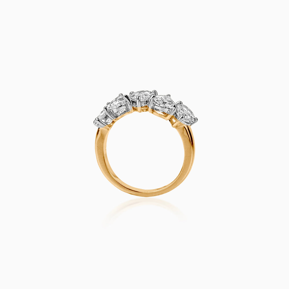 Gold ring with five large white diamond stones in a curved setting