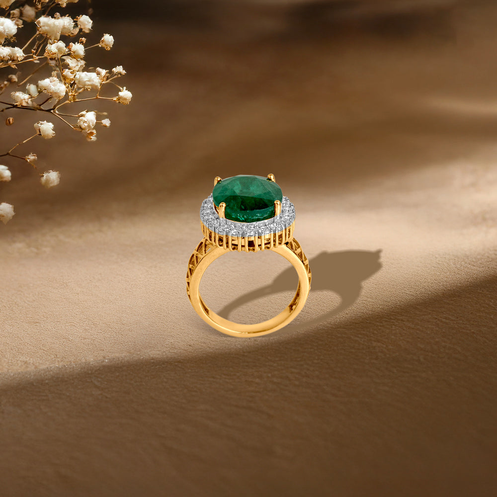 Gold ring with emerald center stone surrounded by diamond halo, elegant styling with baby's breath flowers.