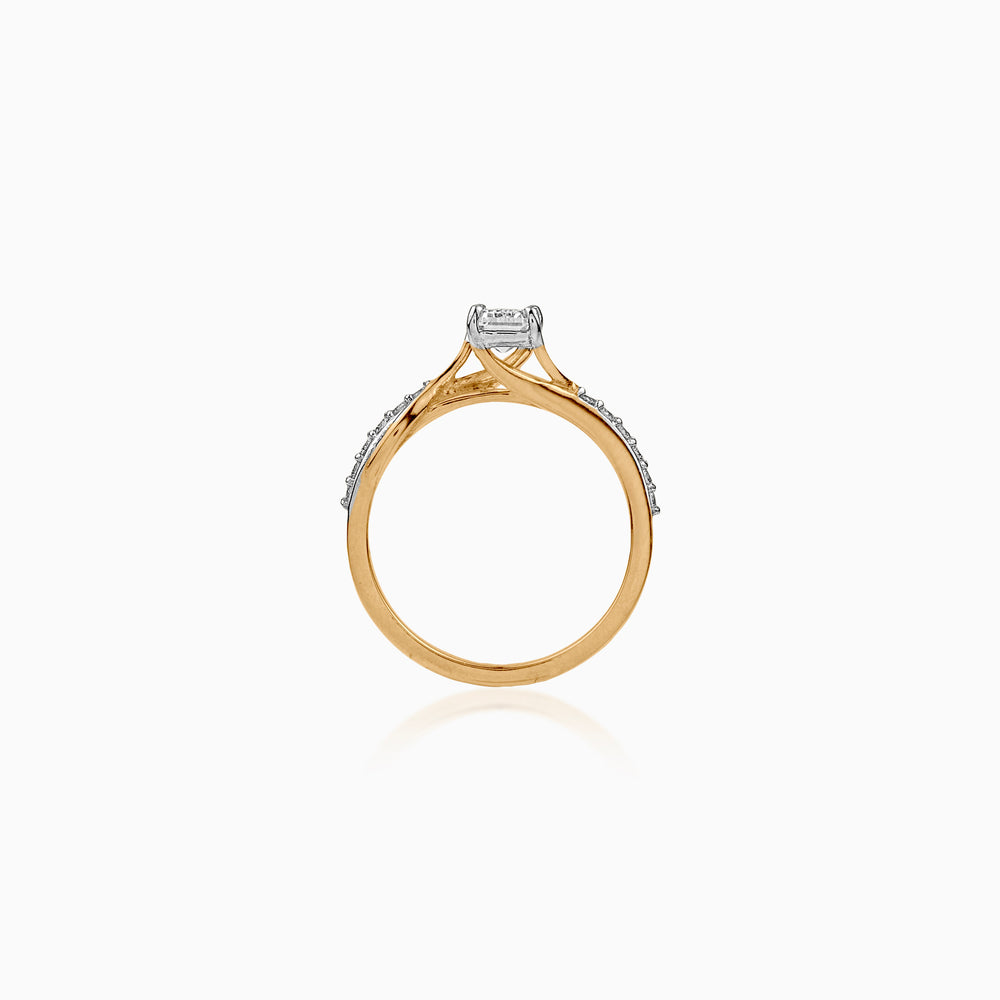 Gold engagement ring with diamond, white background, side view