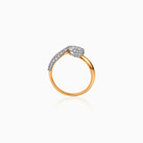 Gold ring with diamond-encrusted curved sections on white background