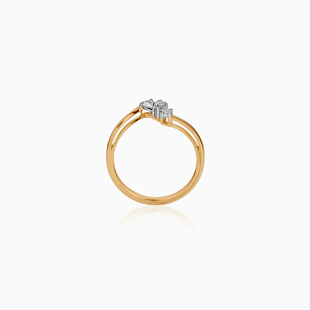 Gold ring with small diamond cluster, minimalist design against white background