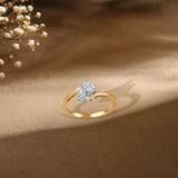 Gold ring with two-stone diamond design, delicate baby's breath flowers in soft focus